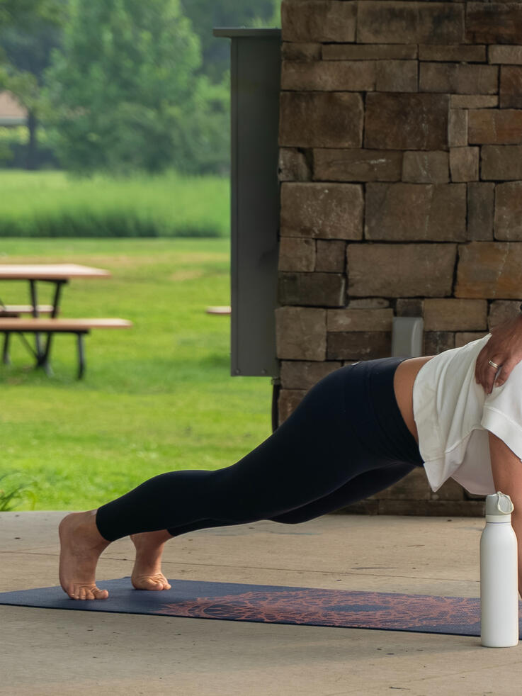Planking Instructor guiding participants planking form.