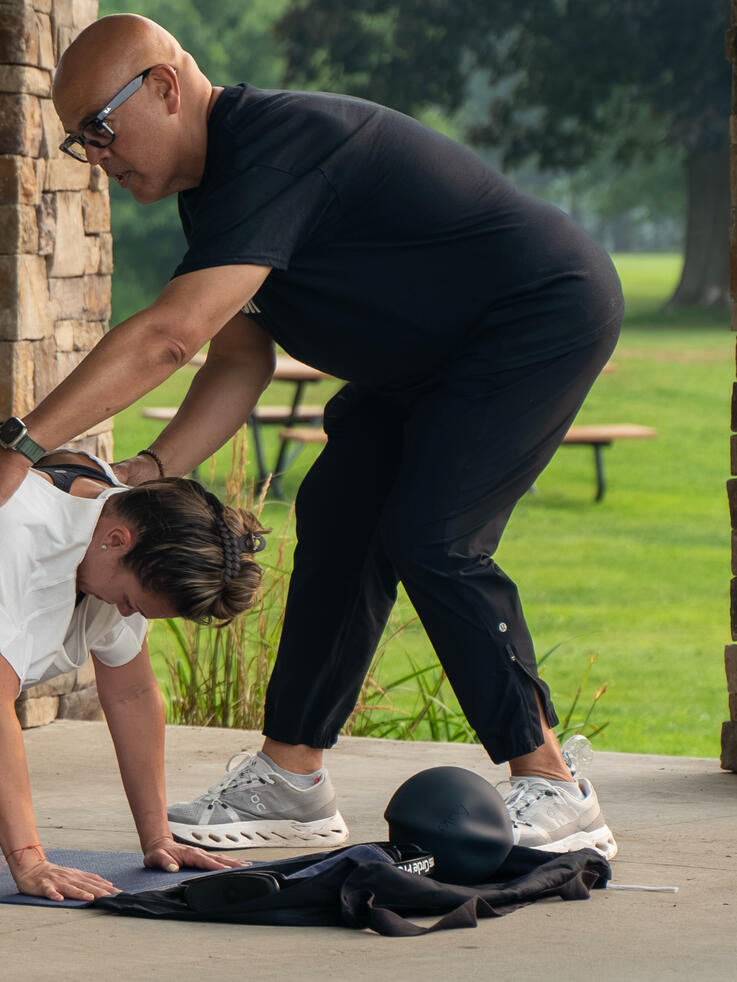 Planking Instructor guiding participants planking form.